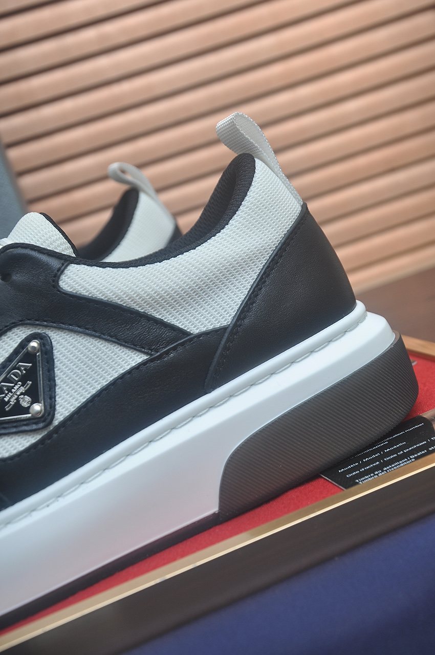 Prada Triangle Plaque Low-Top Sneakers — detail