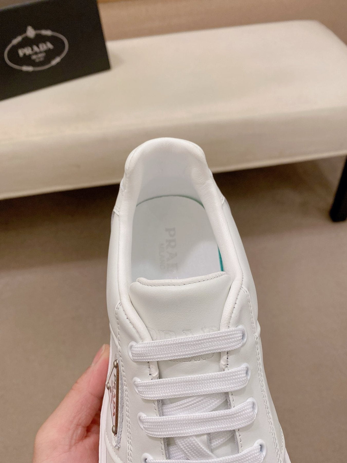 Prada Triangle Plaque Low-Top Sneakers — front