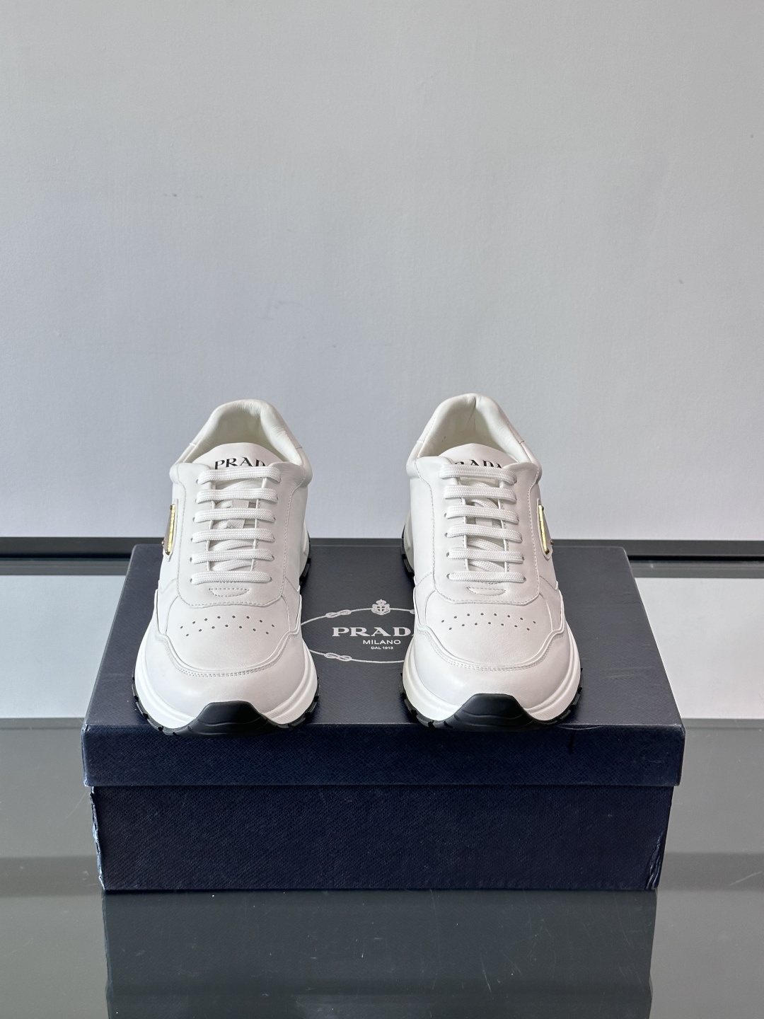 Prada Triangle Plaque Low-Top Sneakers — front