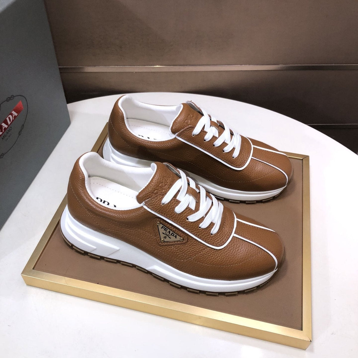 Prada Triangle Plaque Low-Top Sneakers — front