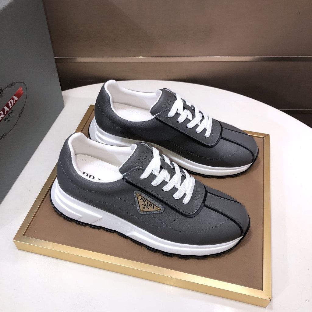 Prada Triangle Plaque Low-Top Sneakers — front