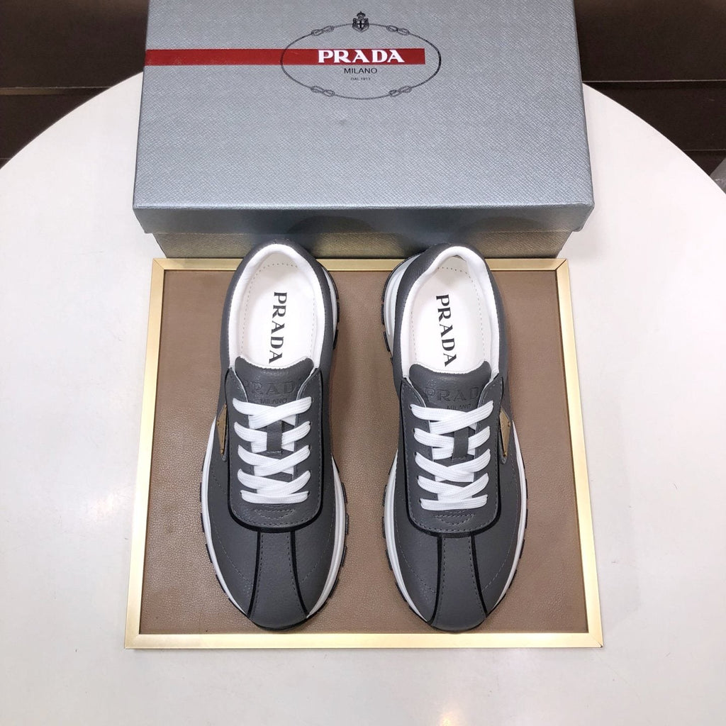 Prada Triangle Plaque Low-Top Sneakers — front