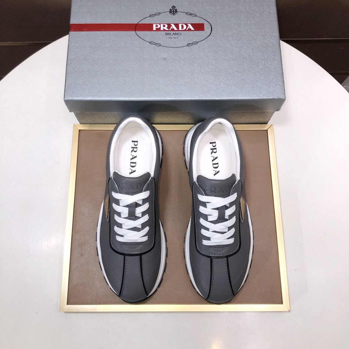 Prada Triangle Plaque Low-Top Sneakers — front