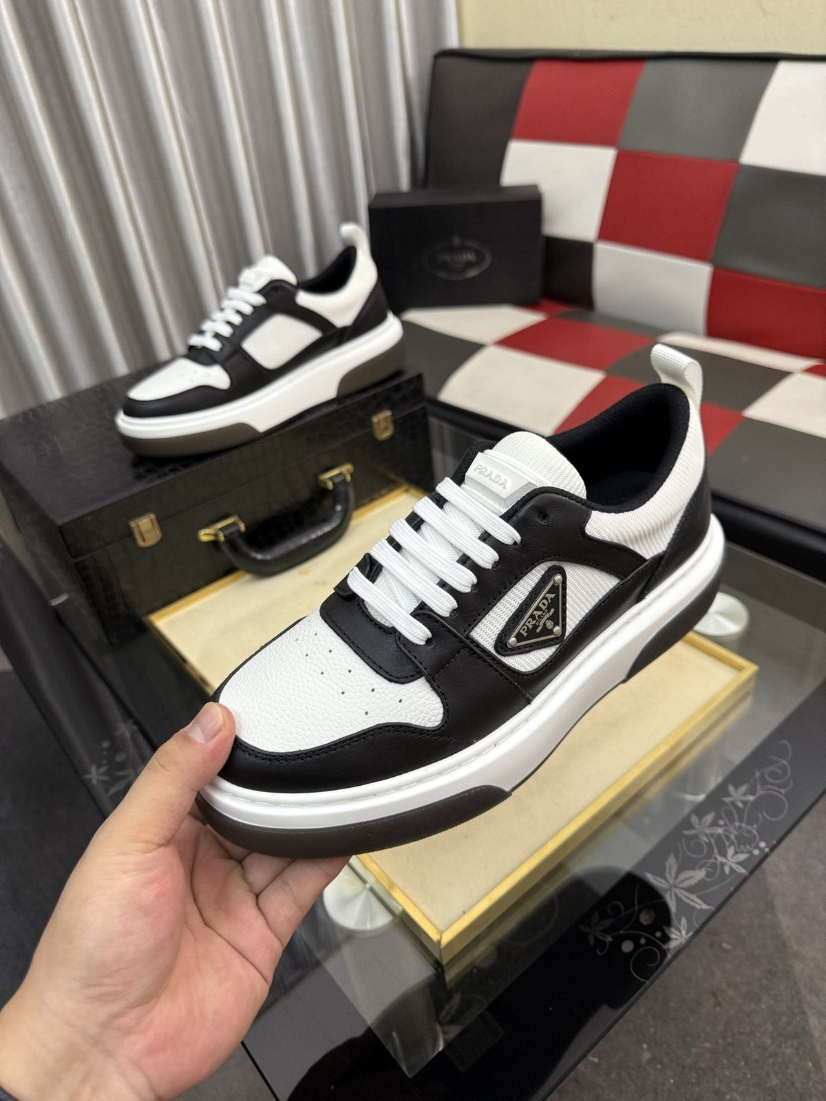 Prada Triangle Plaque Low-Top Sneakers — model