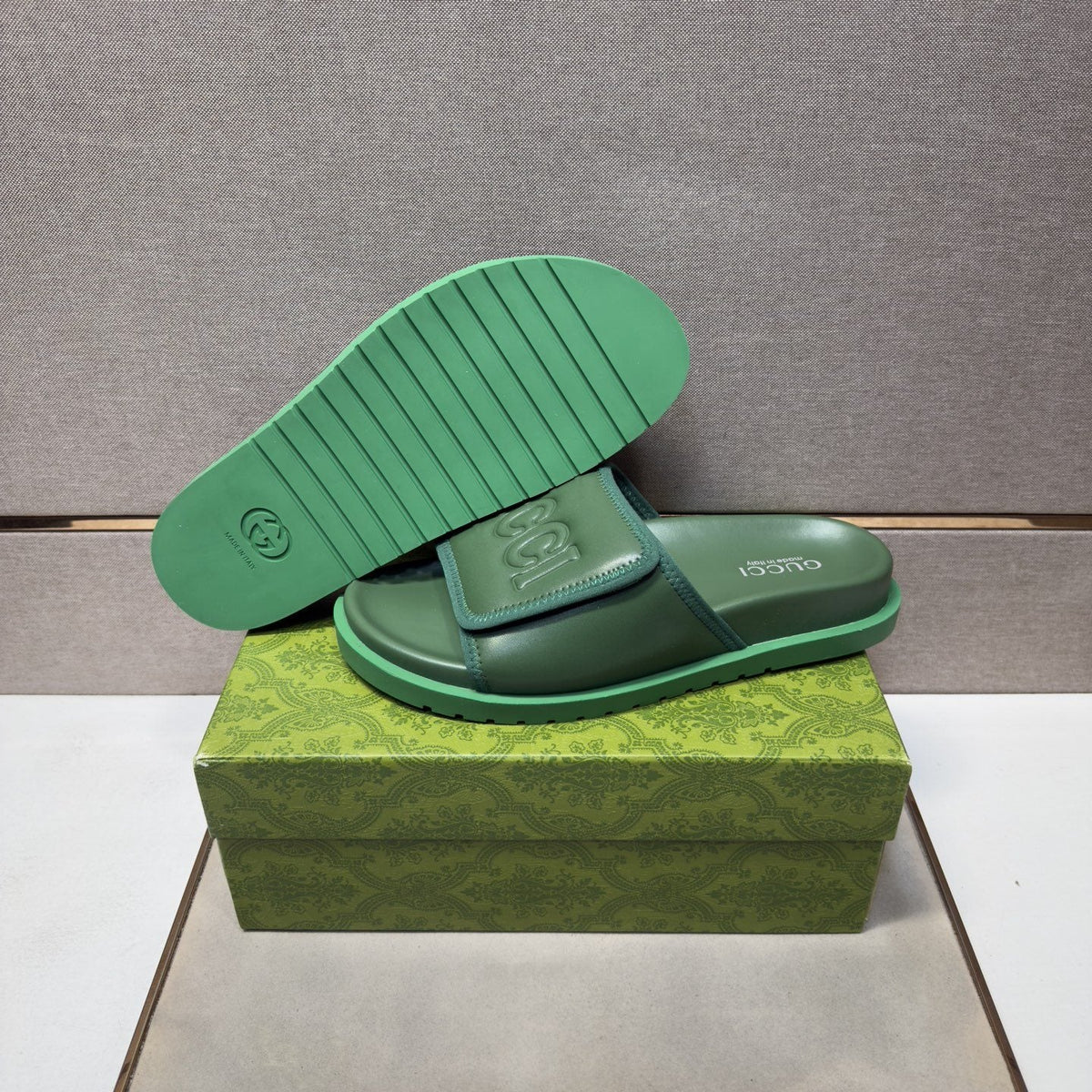 Gucci Raised Logo Slide Sandals — hero